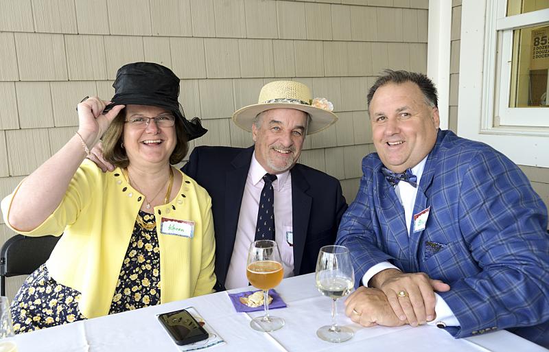 Karen Wright tips her hat while Ron Nichols and Bruce Wright watch for the race to begin.